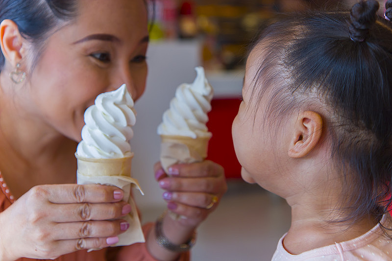 妈妈和小孩一起吃冰淇淋。感觉享受。