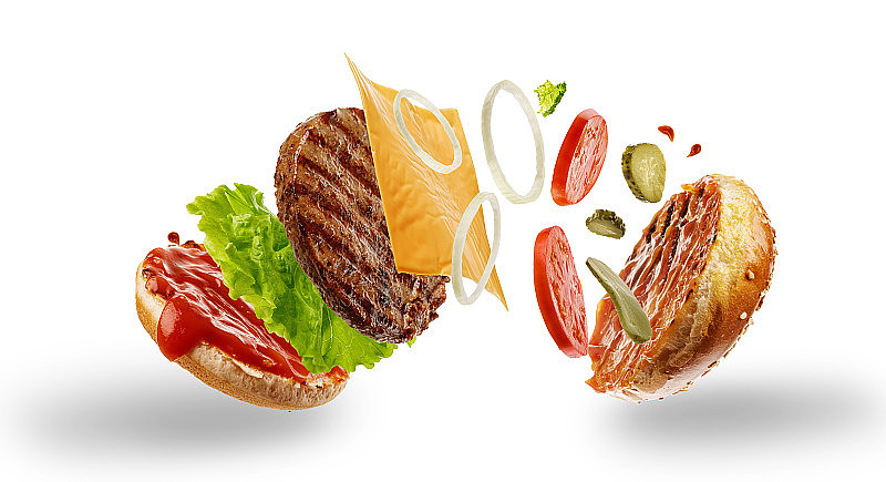 带有飞行元素的汉堡。美味的汉堡与飞行成分隔离在白色背景。食物悬浮的概念