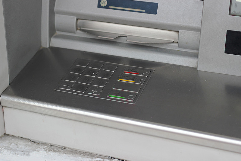ATM机的金属面板，带有键盘，用于密码输入，上面有英文和乌克兰文的铭文