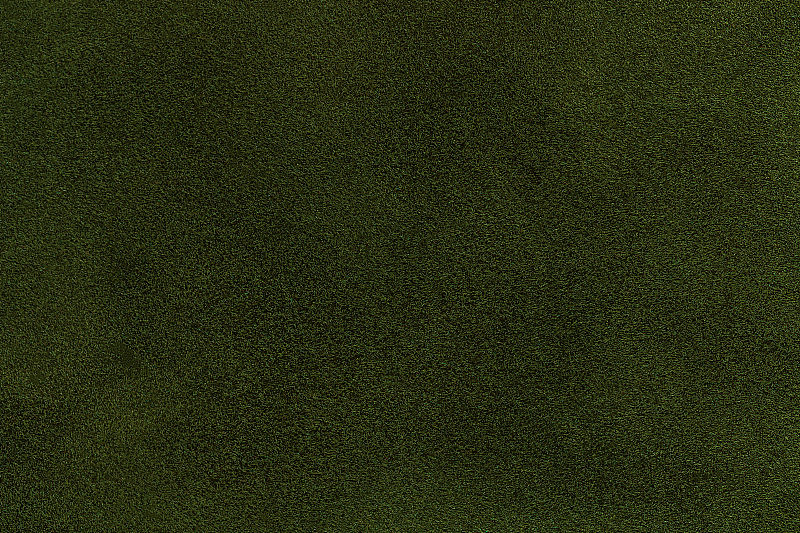 背景深绿色麂皮织物特写。天鹅绒亚光质感的橄榄磨砂织物