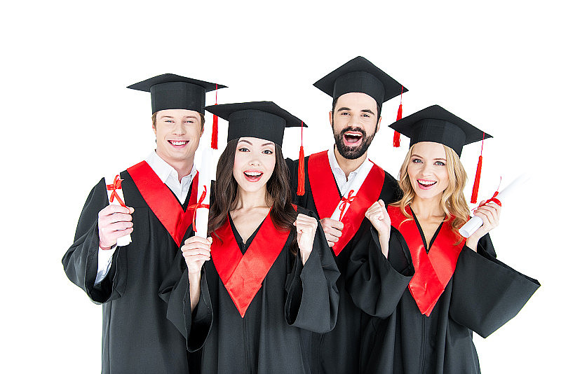 年轻的学生们戴着学术帽，拿着学位证书，对着镜头微笑